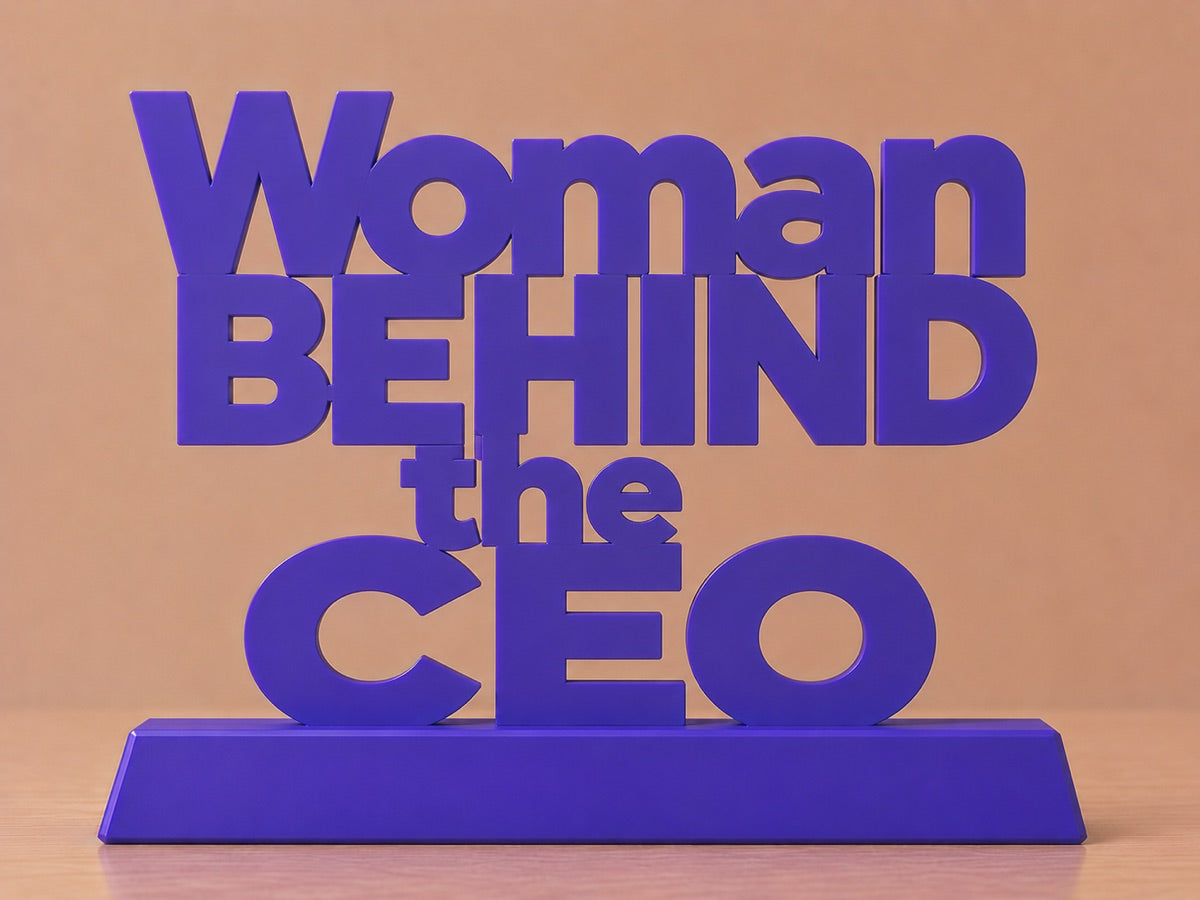 Concept render: stacked desk sign reading Woman Behind the CEO